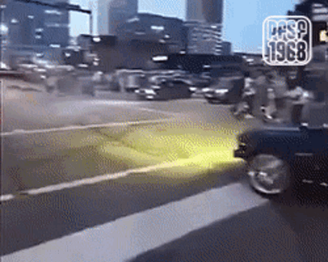 a black car is driving down a street with the year 1968 on the bottom