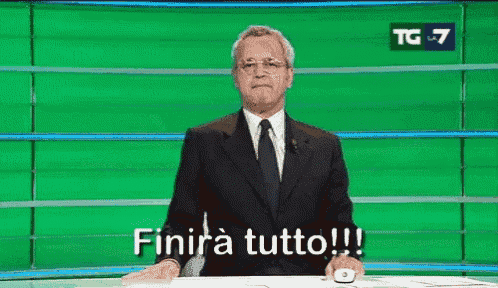 a man in a suit and tie is sitting in front of a green screen that says tg7