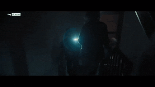 a man is standing in a dark room with a sky cinema logo on the bottom