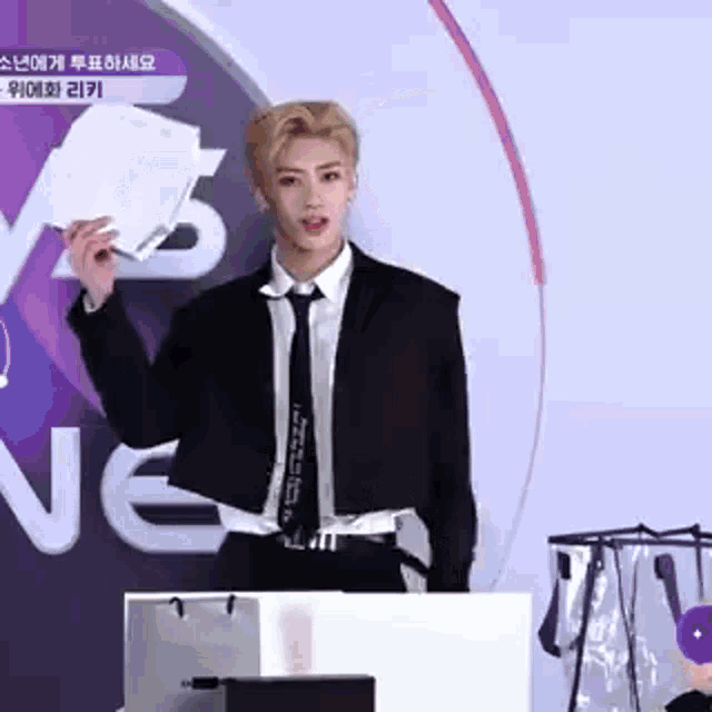 a man in a suit and tie is standing in front of a podium .