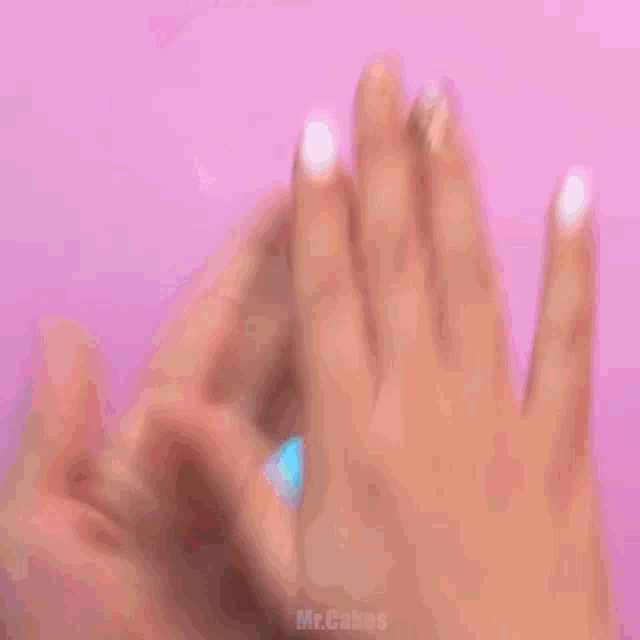 a person holding a blue dolphin in their hand with the words mr.cakes below it