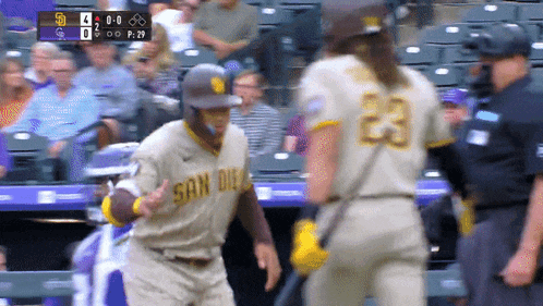 a baseball player wearing a san diego jersey talks to another player