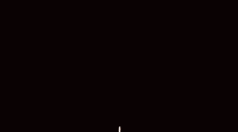 a fireball is exploding in the middle of a circle of flames on a black background .