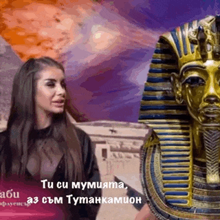 a woman standing next to a statue of a pharaoh .