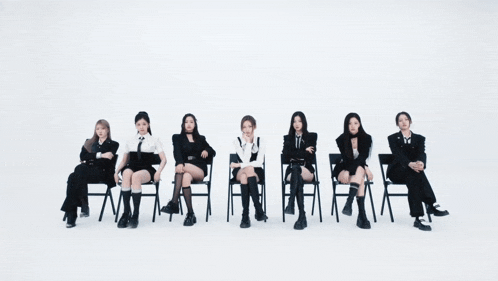 a group of women sitting in chairs in a row