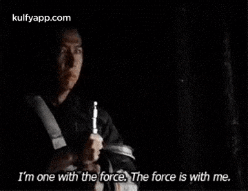 a man is holding a gun in his hand and says `` i 'm one with the force , the force is with me ''