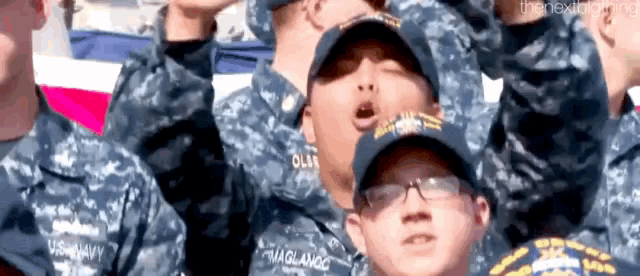 a group of us navy soldiers are standing in a line