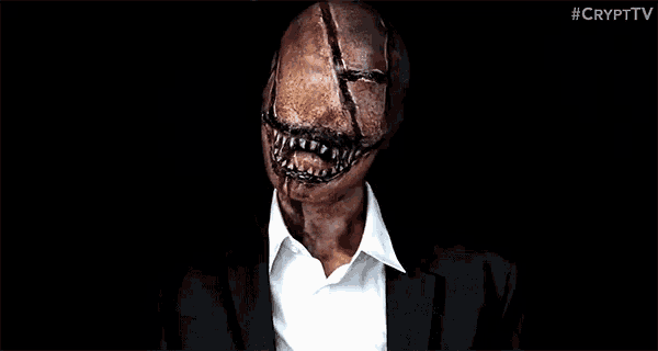a man in a suit and white shirt with a scary face painted on his face