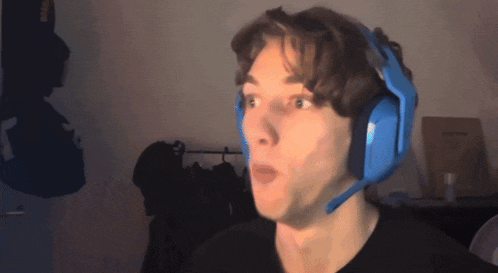 a man wearing blue headphones with a microphone on his head