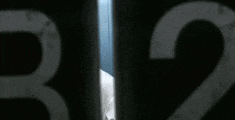 a close up of a person behind a fence with the numbers 32 on it .