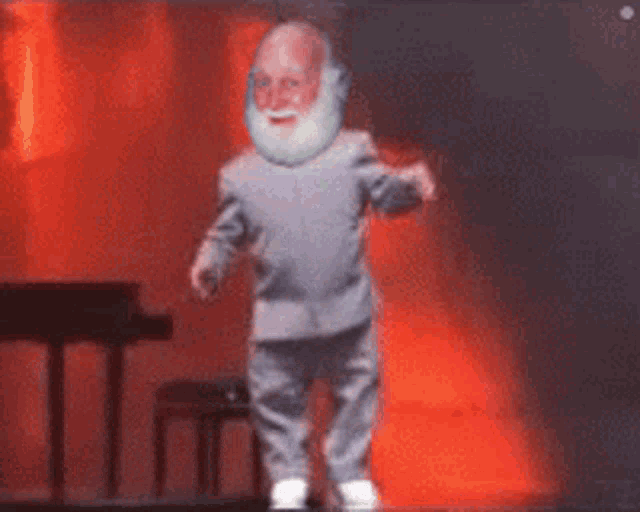 a man with a beard is dancing on a stage with a piano in the background
