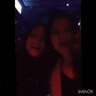 two women are sitting next to each other in a car with the words inshot on the bottom right