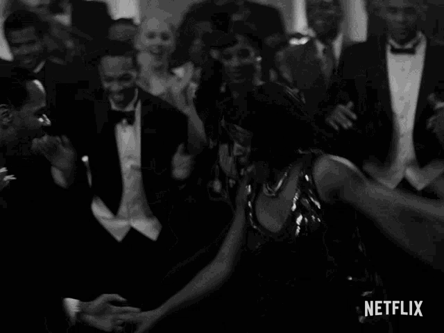 a black and white photo of people dancing with a netflix logo in the background
