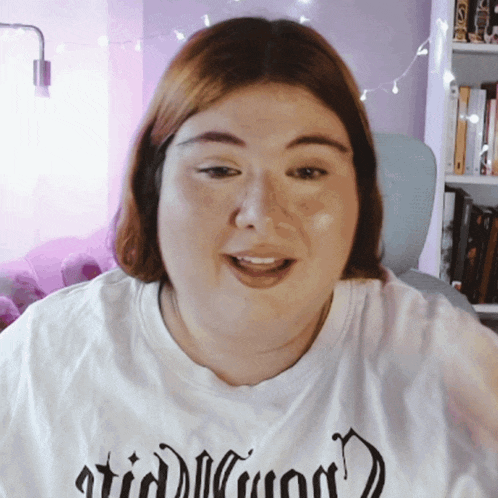 a woman wearing a white t-shirt that says ' astrid ' on the front