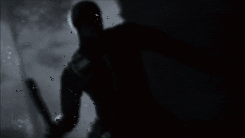 a silhouette of a person in the rain with a white face