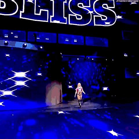 a woman in a wrestling outfit is standing on a stage with a wwe championship belt around her waist