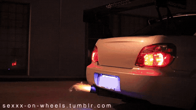 a car with a flame coming out of the exhaust pipe is being photographed by sexxx-on-wheels.tumblr.com