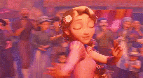 rapunzel from tangled is dancing in front of a crowd of people with a flower in her hair .