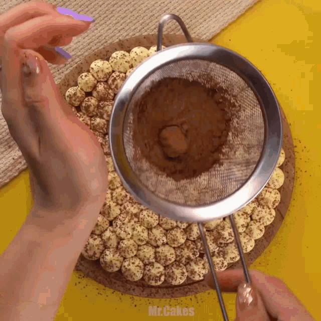 a person is sifting cocoa powder into a cake with mr.cakes written on the bottom