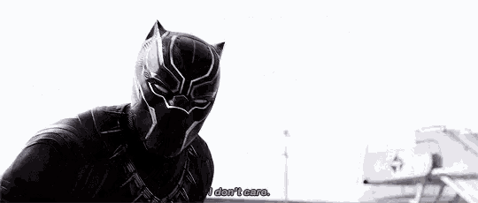 a black panther is standing in front of a building and saying `` i do n't care '' .