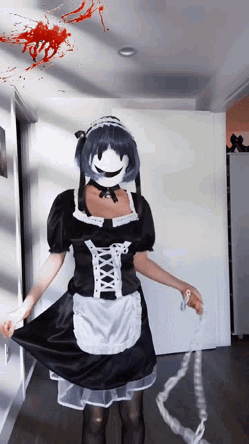 a woman in a maid costume holds a chain