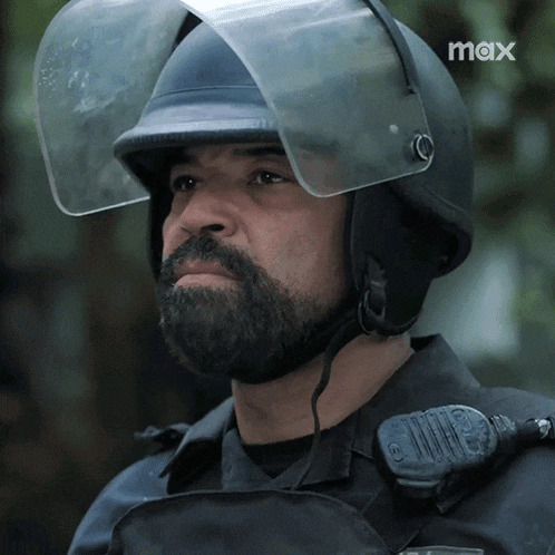 a man with a beard wears a helmet with a clear visor and the word max on the bottom right
