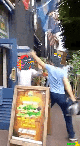 a man in a blue shirt is standing in front of a sign that has a hamburger on it