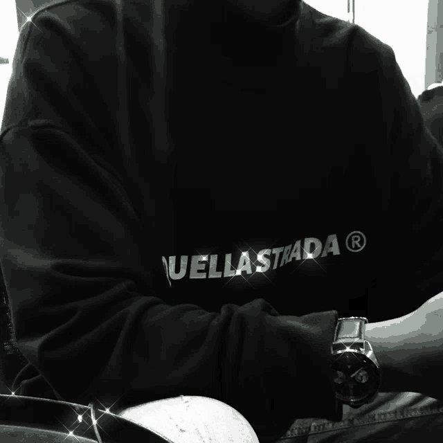 a person wearing a black shirt that says uellastrada