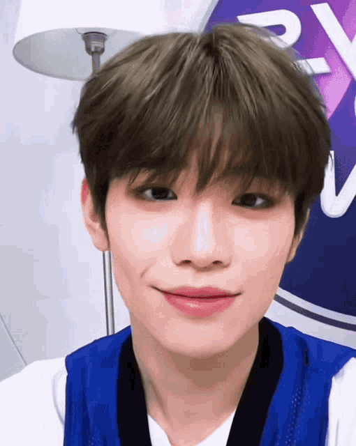 a close up of a person 's face in front of a sign that says ' rv ' on it