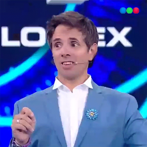 a man in a blue suit stands in front of a sign that says loex