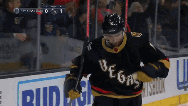 a hockey player wearing a jersey that says " vegas " on it