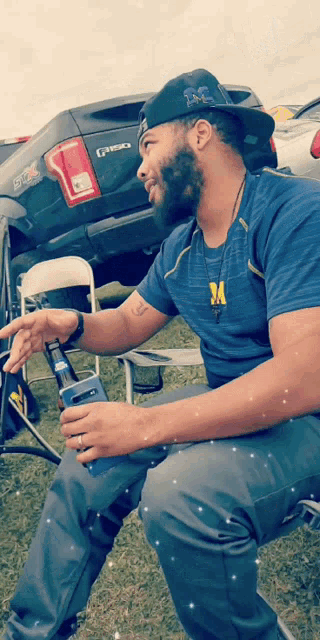 a man sitting in front of a ford truck