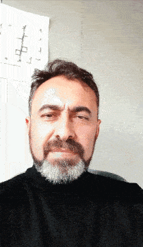 a man with a beard wears a black turtleneck sweater