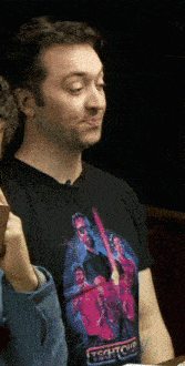 a man wearing a black t-shirt that says technicolor on it