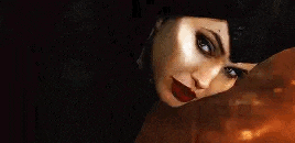 a close up of a woman 's face with red lipstick and a hat .