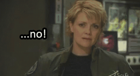 a woman is standing in a room with the words `` no '' on her face .