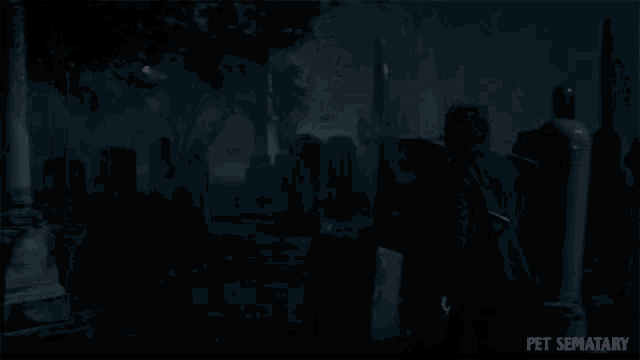 a man holding a shovel in a cemetery with pet sematary written on the bottom