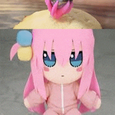 a doll with pink hair and blue eyes is sitting on the floor