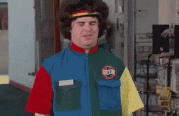 a man wearing a colorful shirt with a nike logo on it is standing in a room .