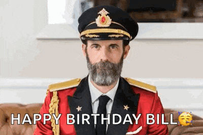 a man in a military uniform is sitting on a couch and says `` happy birthday bill '' .