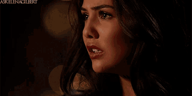 a close up of a woman 's face with the words askelenagilbert in the upper right corner