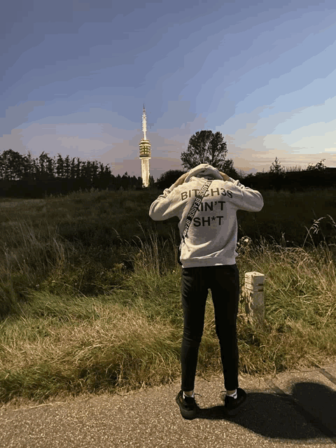 a person wearing a sweatshirt that says bitch is in 't shit