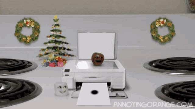 an apple with a face on it sits on top of an annoyingly orange printer