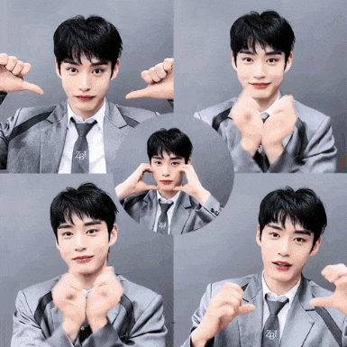 a young man wearing a suit and tie is making a heart shape with his hands