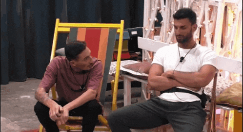two men are sitting next to each other in lawn chairs