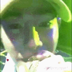 a close up of a person 's face with a green background that says ' yongyun ' at the bottom