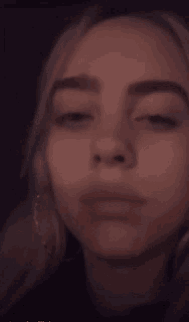 a close up of a woman 's face in the dark