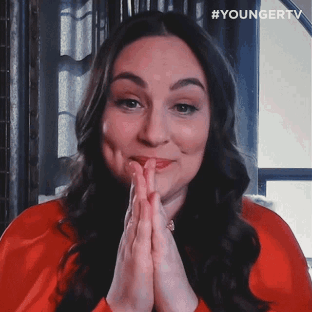 a woman with her hands folded and a #youngertv watermark