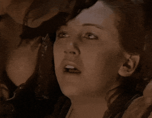 a close up of a woman 's face with a surprised expression