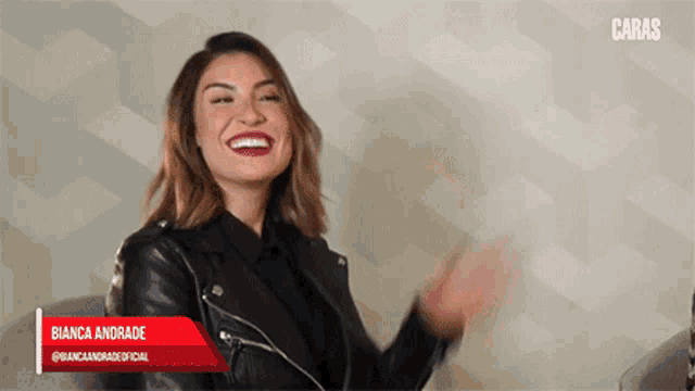 a woman wearing a black leather jacket with the name bianca andrade on the bottom